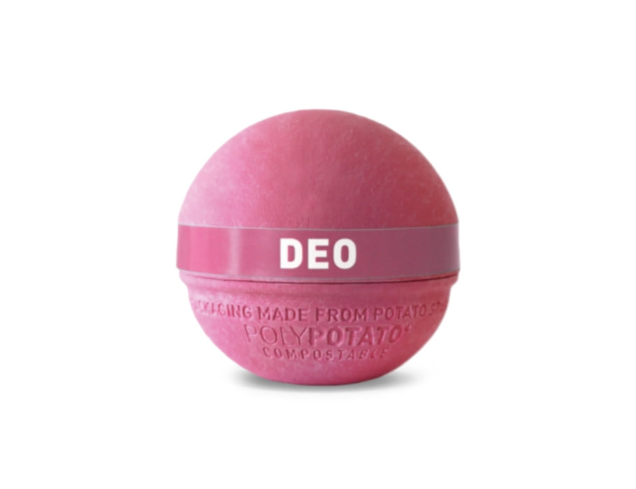 Roze ronde deodorantbal van Ben & Anna, gemaakt van composteerbare PolyPotato®-verpakking, met een roze band waarop “DEO” staat.