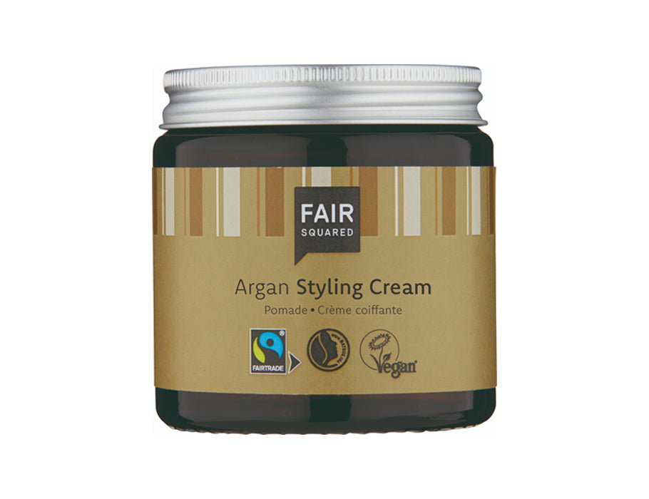 Fair Squared Argan Styling Cream in een donkerbruin glazen potje met zilveren schroefdop en goudkleurig etiket met verticale strepen; fairtrade en vegan haarcrème.