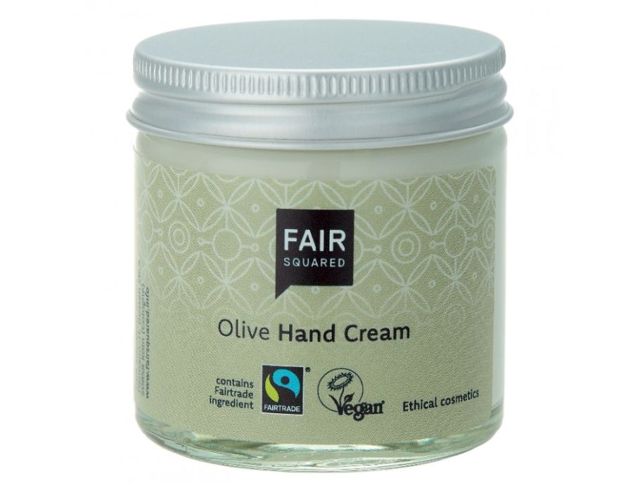 Fair Squared Olive Hand Cream in een transparant glazen potje met zilveren schroefdop en lichtgroen etiket met subtiel patroon; fairtrade en vegan handcrème met olijf.